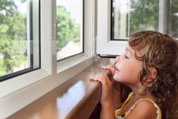 Young girl looking out of the window